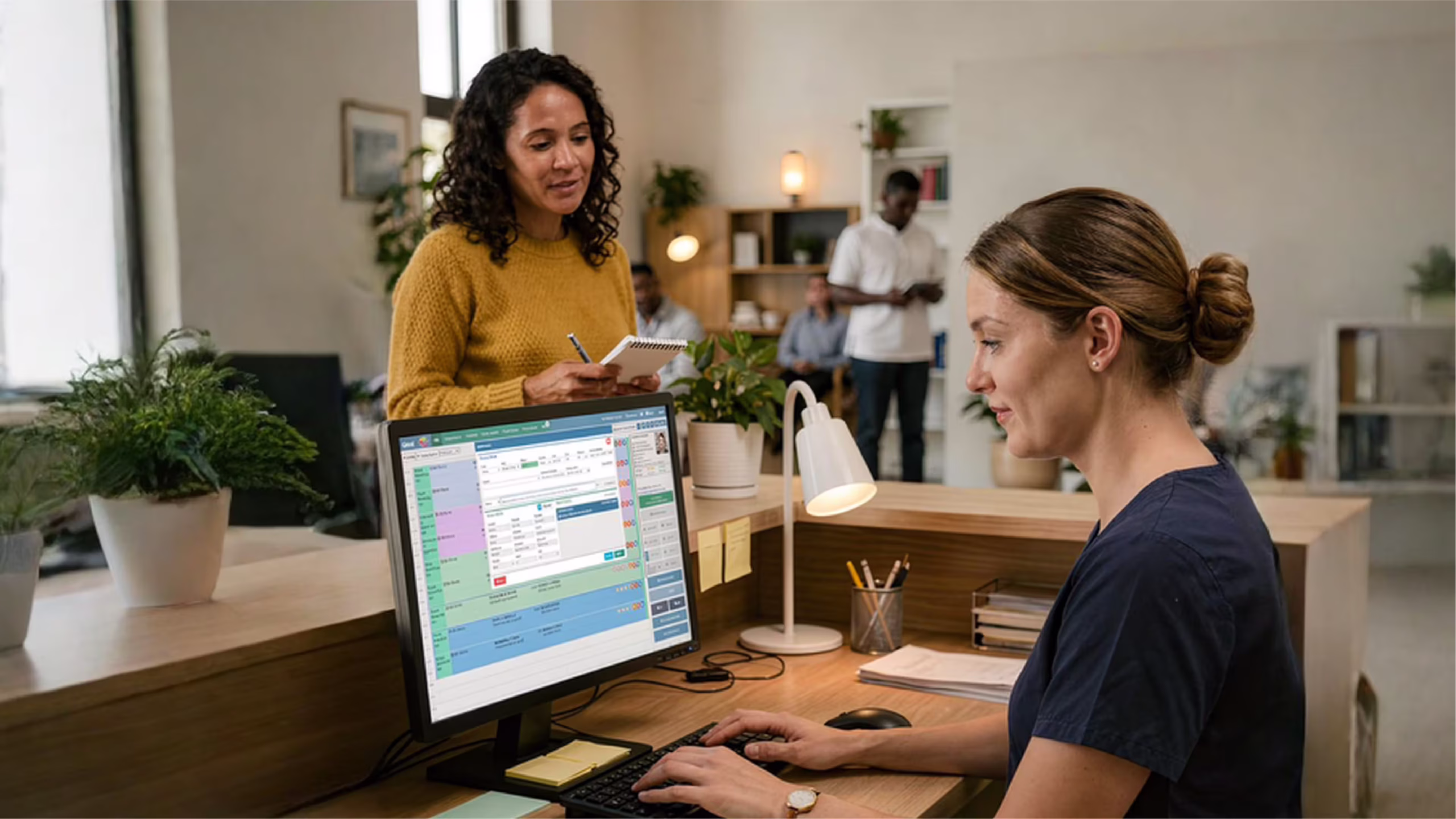 Dental receptionist managing appointments on cloud-based software in NZ practice