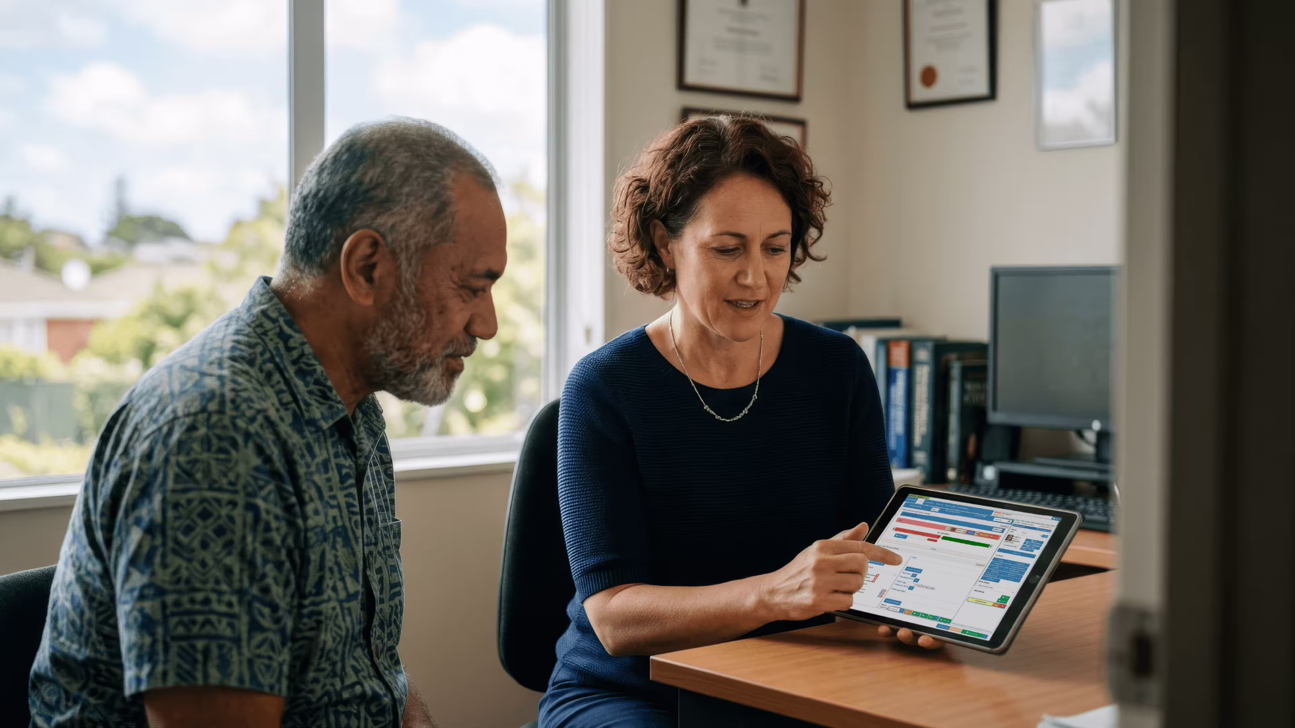 GP reviewing EMR software with a patient in a New Zealand medical practice